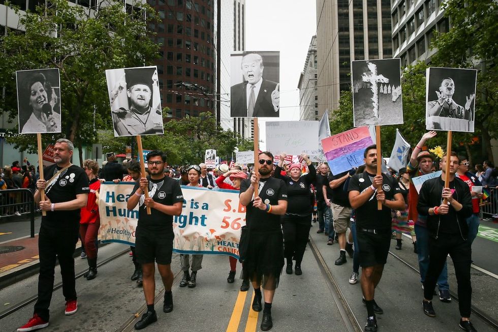 A group of marchers likens U.S. President Donald Trump to Anita Bryant, the KKK and Adolf Hitler while marching in the annual LGBTQI Pride Parade on Sunday, June 25, 2017 in San Francisco, California. The LGBT community gathered on Market Street for the 47th annual Pride Parade.