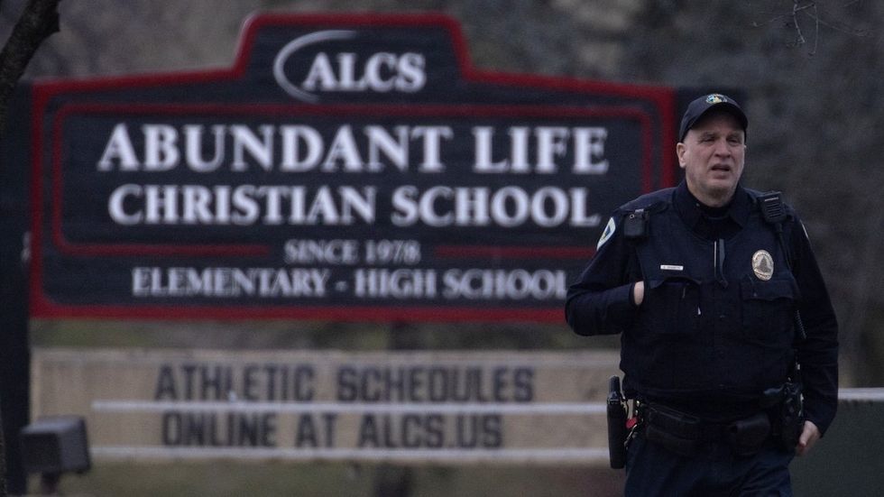 A police officer stands guard in front of Abundant Life Christian School on December 16, 2024 in Madison, Wisconsin.