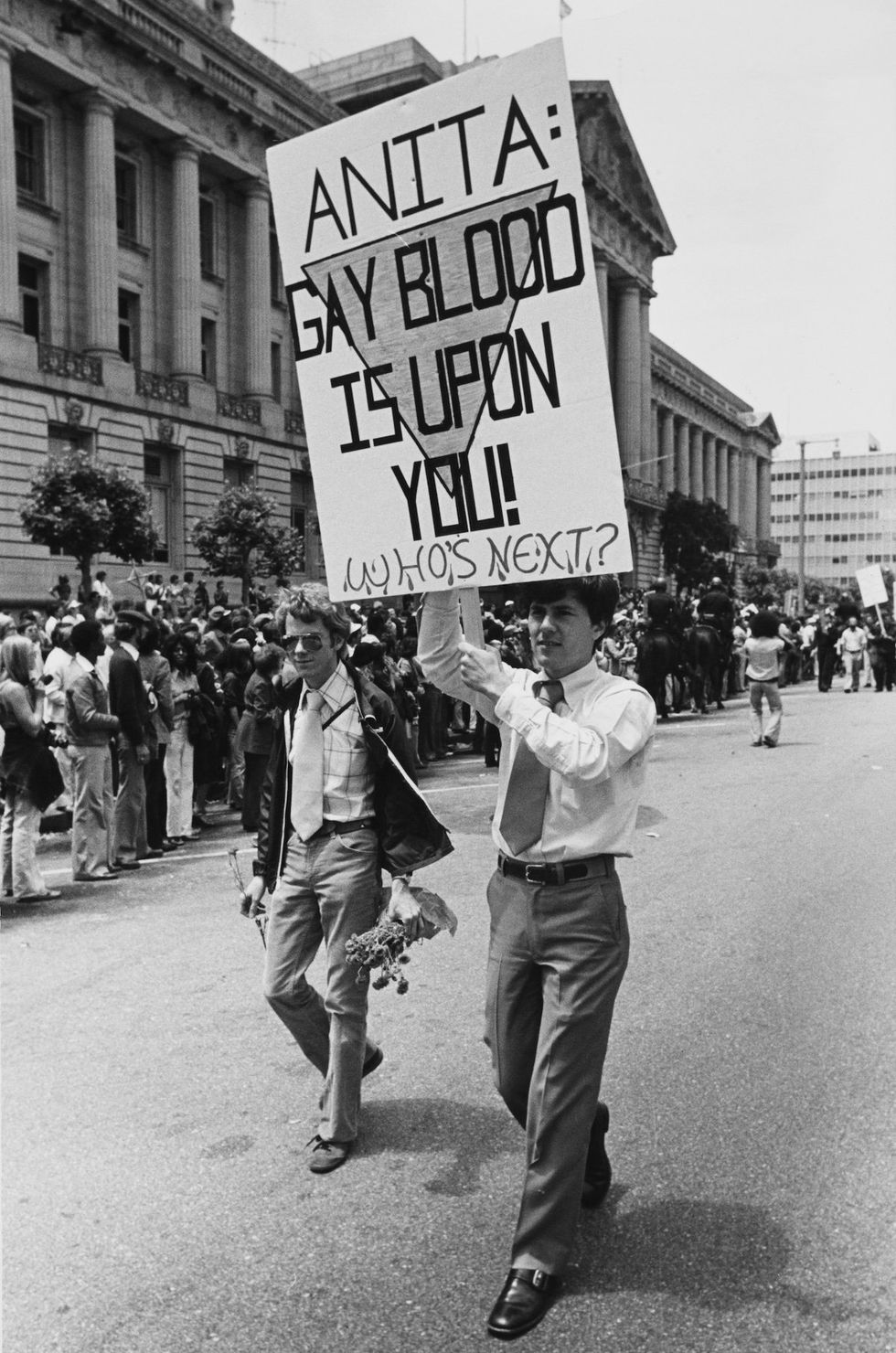 An activist holds a placard that reads, 