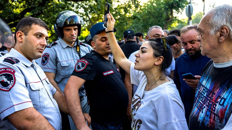 Anti government demonstrators clash with Armenian police forces outside of the Parliament in Yerevan