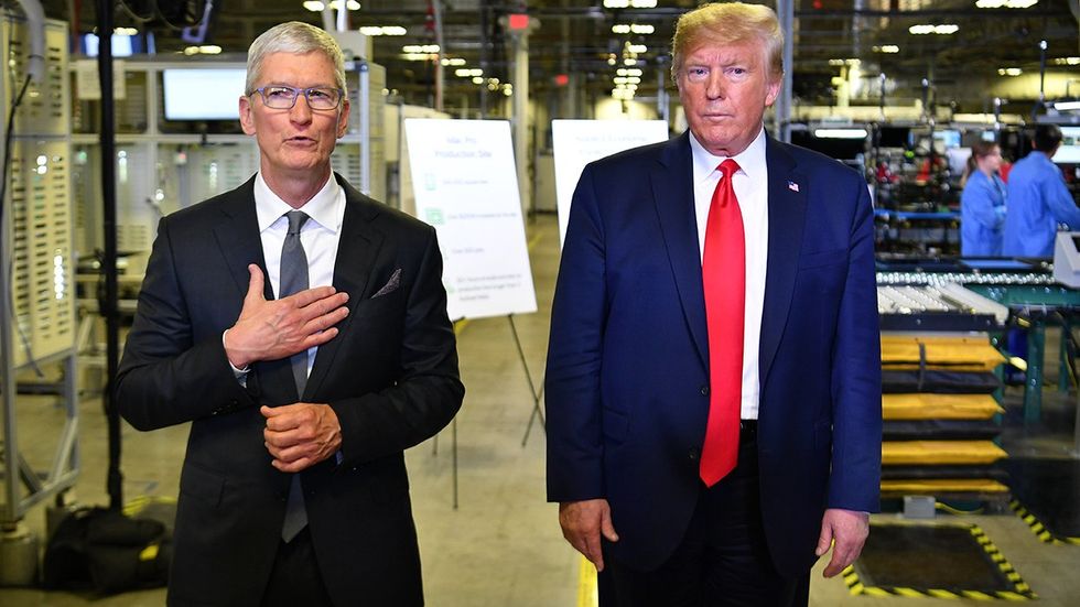 Apple CEO Tim Cook US President Donald Trump speak to the press during a tour of the Flextronics computer manufacturing facility where Apple Mac Pro computers are assembled