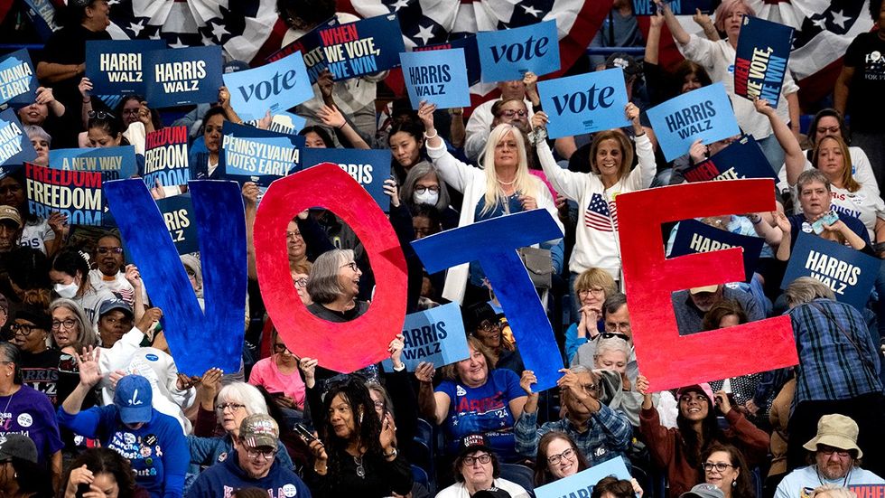 crowd holds a VOTE sign during a rally for Vice President Kamala Harris at University of Pittsburgh PA