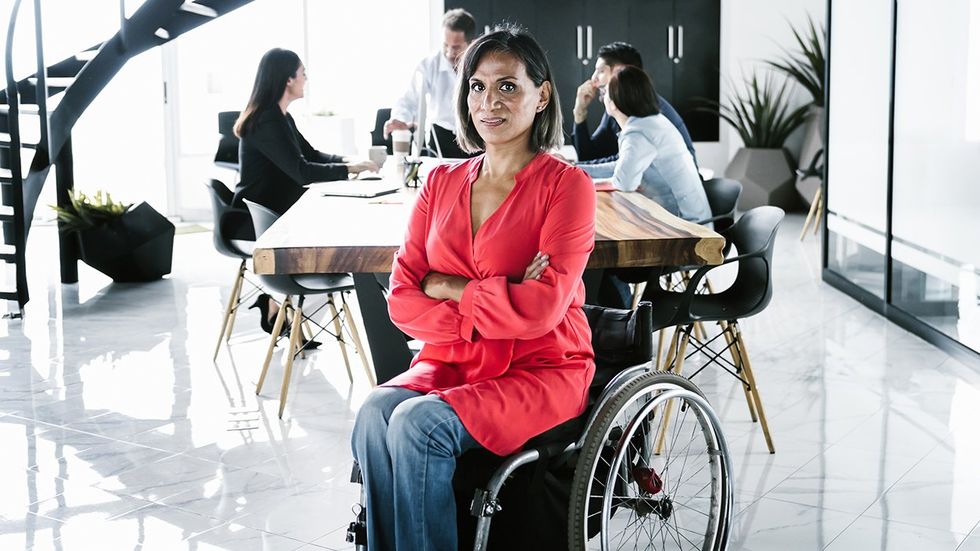 Disability Pride Month transgender woman wheelchair conference room work meeting