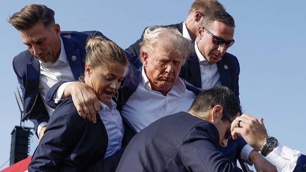 Donald Trump being escorted away by U.S. Secret Service after shooting incident in Pennsylvania