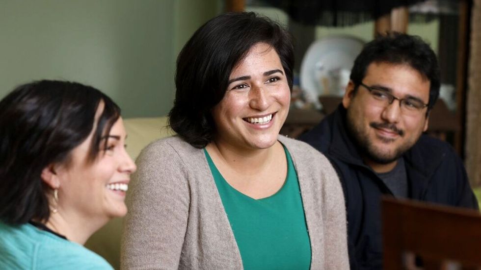 Emily Randall pictured middle while campaigning poised to be first queer Latina in Congress after Washington primary win