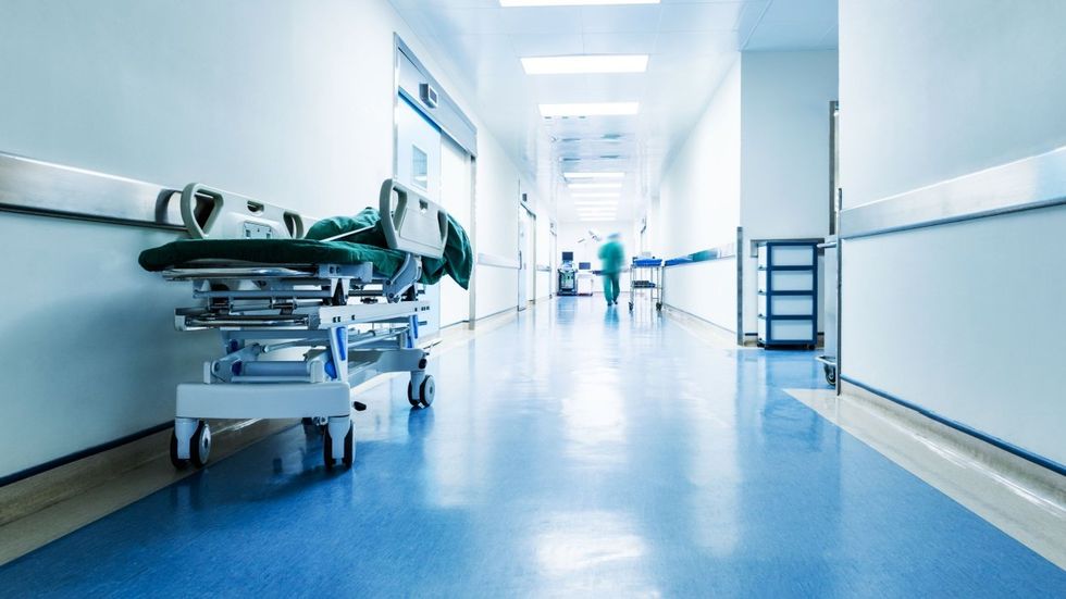 empty hospital corridor with one bed