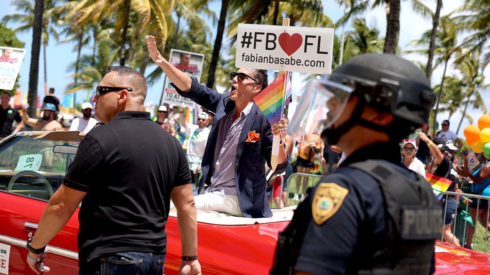 Florida State House Rep Fabian Basabe is flanked by security as he rides in the LGBTQ Pride Celebration parade 2023 Miami Beach Florida