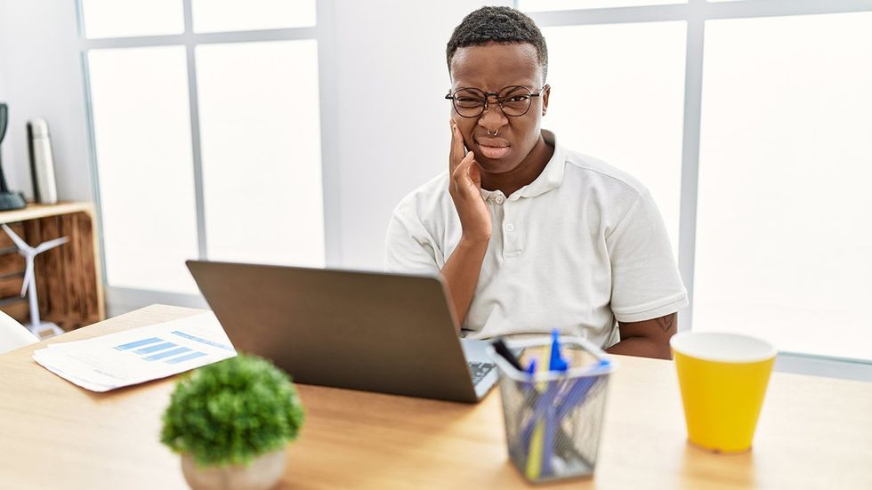 frustrated transgender person working in an office