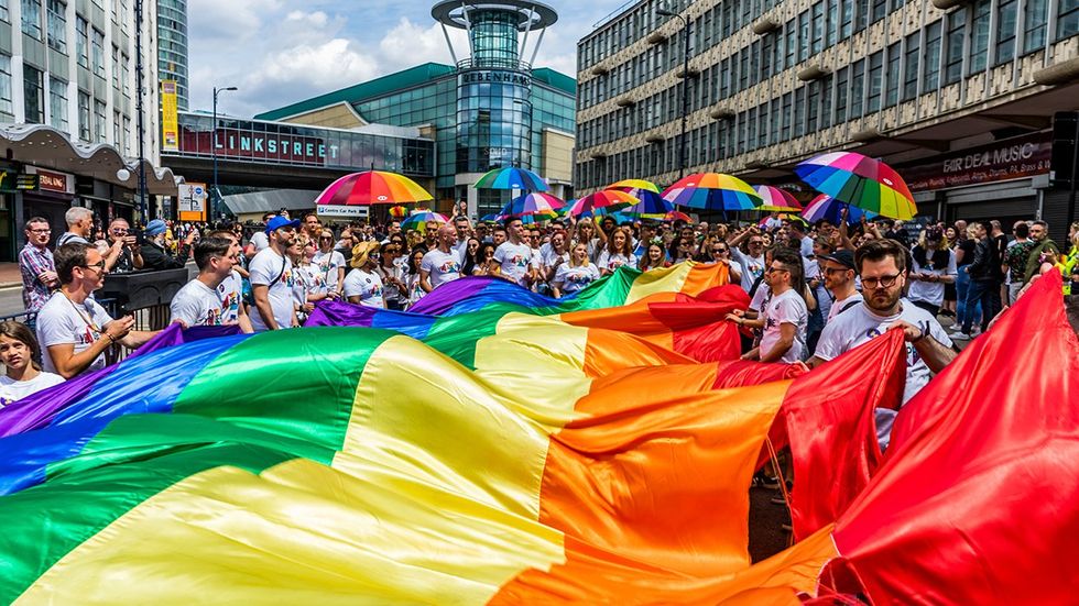 Gay Village Hurst Street Birmingham UK LGBTQIA Pride parade huge rainbow flag and umbrellas