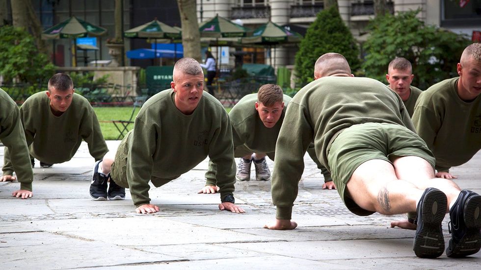 group of US Marines doing push ups during an early morning boot camp exercise in Bryant Park at Marine Day during Fleet Week NYC