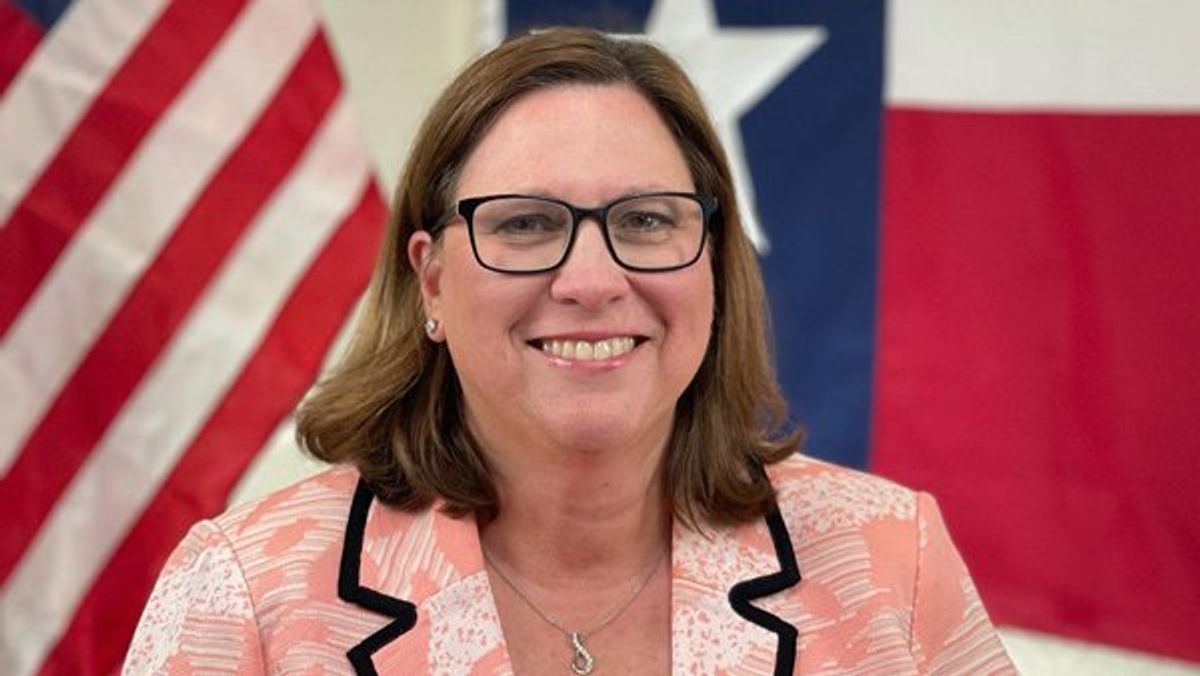 Julia Johnson in front of United States and Texas flags