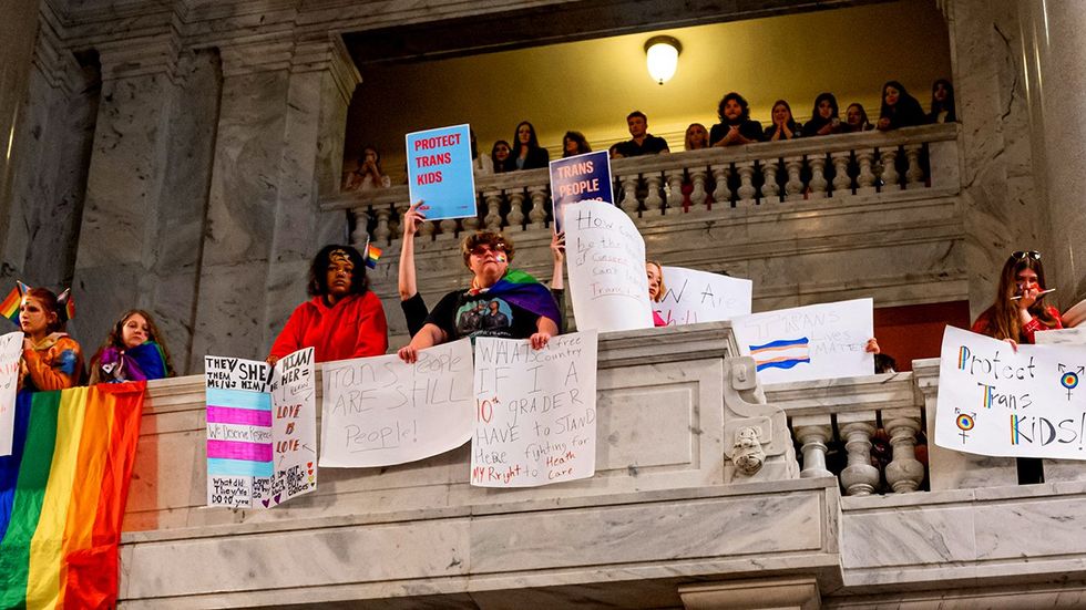 Kentucky State Capitol protesters protect trans kids lgbtq rainbow flag SB 150 Dont Say Gay bill vetoed by Kentucky Governor Andy Beshear