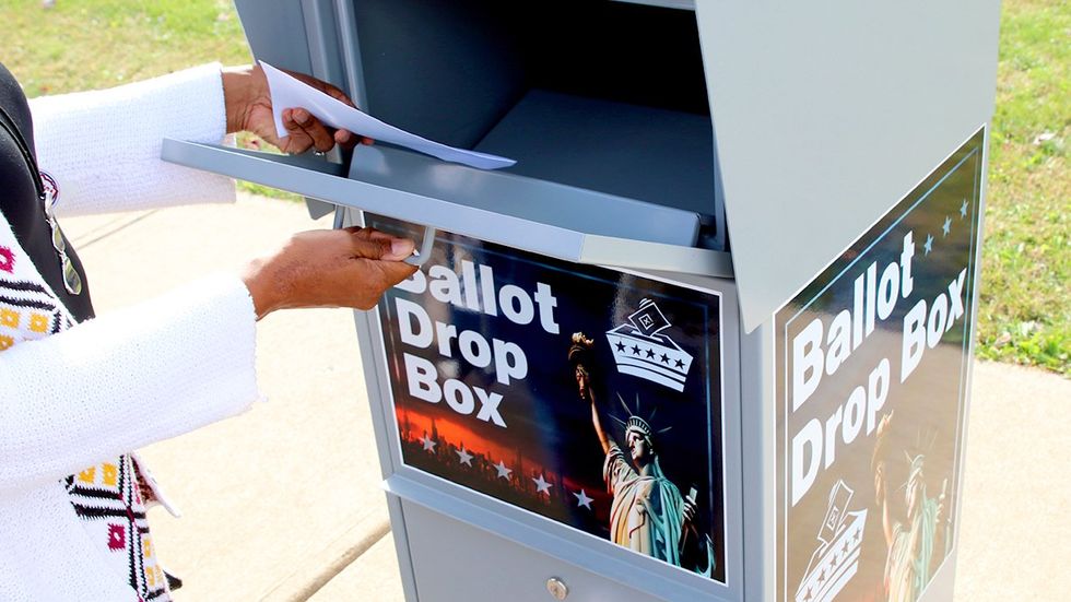 Lancaster Ohio voter places ballot in drop box outside Board of Elections Office