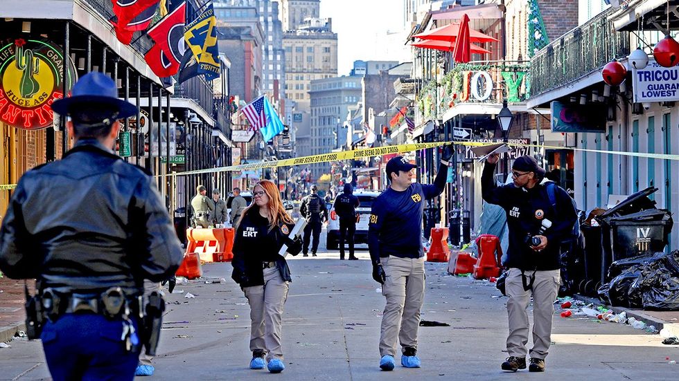 Law enforcement officers from multiple agencies work the scene on Bourbon Street after at least ten people were killed when a person allegedly drove into the crowd in the early morning hours of New Years Day 2025 New Orleans Louisiana