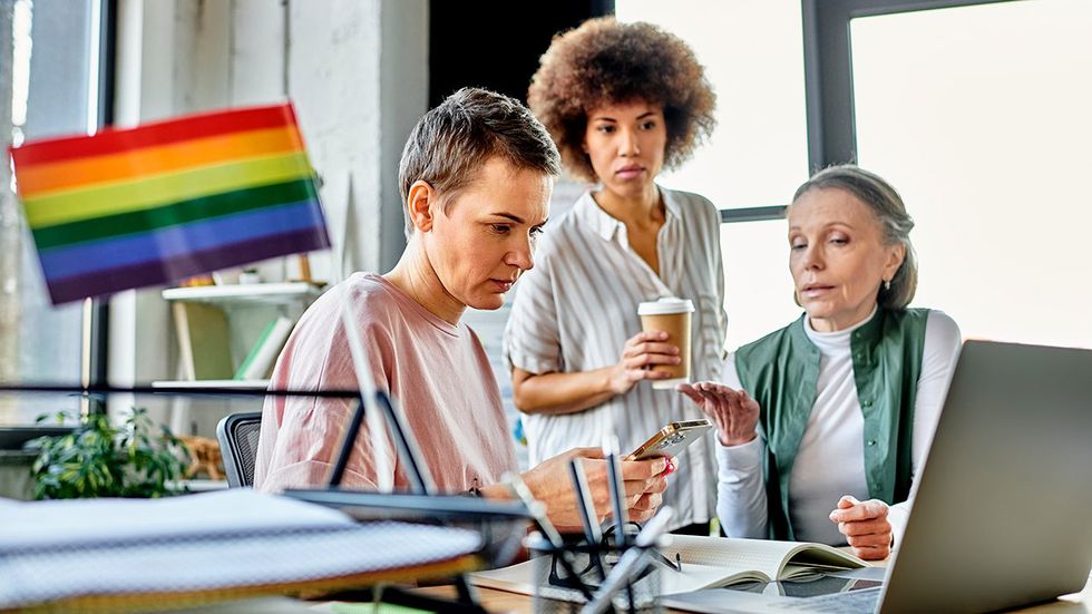 lgbtqia employees coworkers discussing DEI being pulled from company package