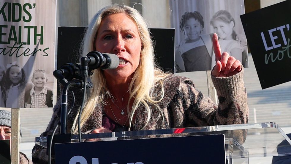 Marjorie Taylor Greene speaks outside the US Supreme Court building during a rally as the high court hears arguments in a case on transgender health rights