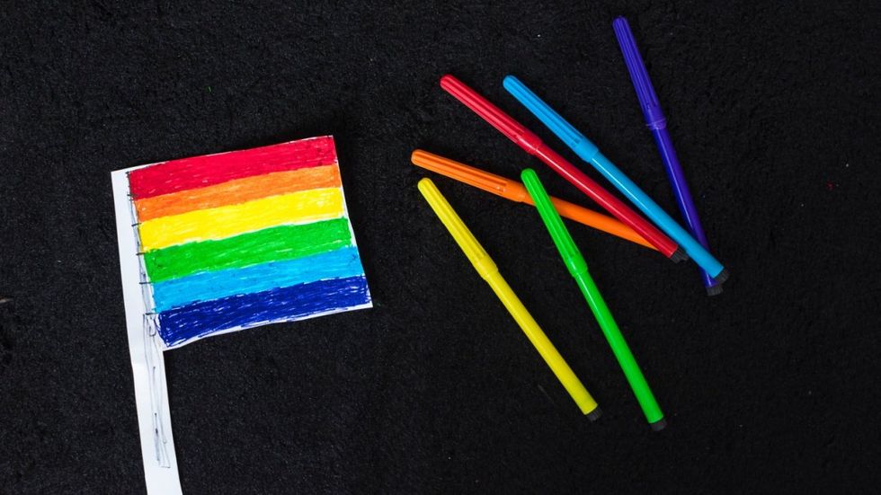 Markers and a Pride flag made from paper 