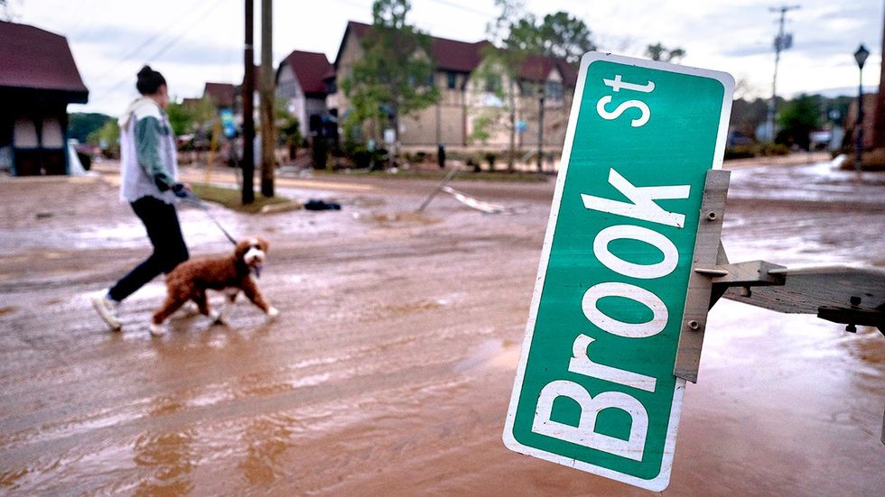 Mary Grace and her dog Marley walk around the Biltmore Village in the aftermath of Hurricane Helene September 2024 Asheville North Carolina