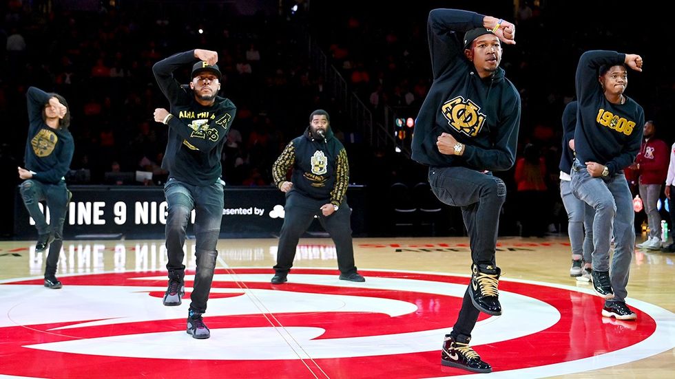 Members Alpha Phi Alpha Fraternity Inc perform step routine NBA basketball game New York Knicks Atlanta Hawks