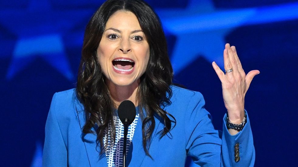 Michigan Attorney General Dana Nessel shows her wedding band as she speaks on the third day of the Democratic National Convention