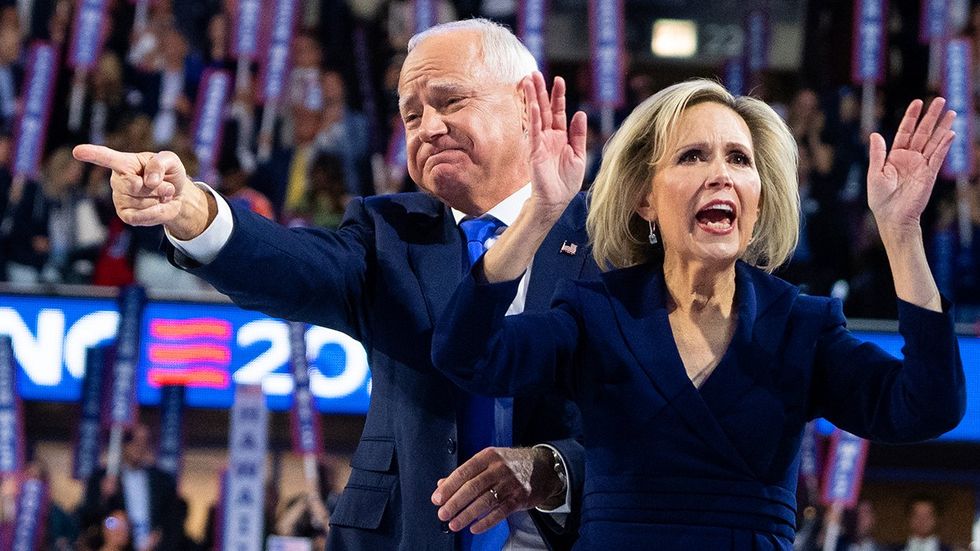 Minnesota Governor Tim Walz Democratic vice presidential nominee and his wife Gwen cheer with the crowd after he spoke on the third night of the Democratic National Convention