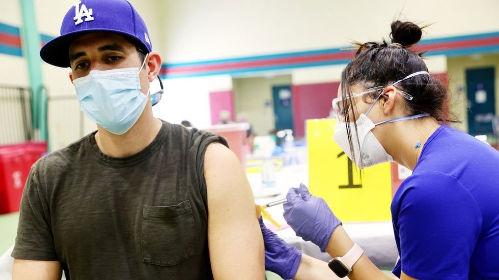 nurse administers mpox vaccine to a person