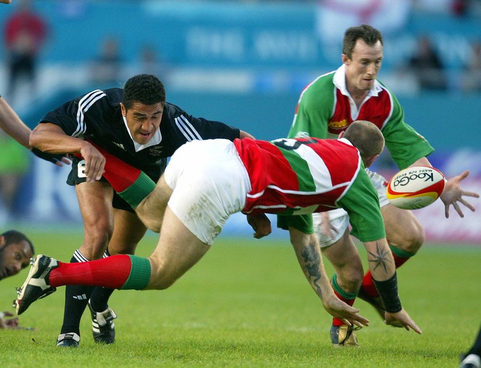 Olympic Rugby Sevens Team Mils Muliaina of New Zealand stops Welshman Gareth Thomas during a quarter-final cup match at the XVII Commonwealth Games in Manchester