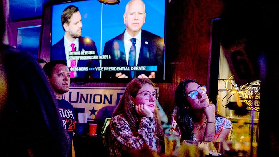 Patrons watch vice presidential debate between Republican candidate JD Vance Democratic candidate Tim Walz Union Pub Capitol Hill October 2024