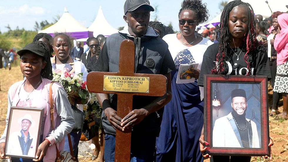 Relatives carry potraits of Kenyan LGBTQ activist Edwin Chiloba during his funeral in Sergoit village