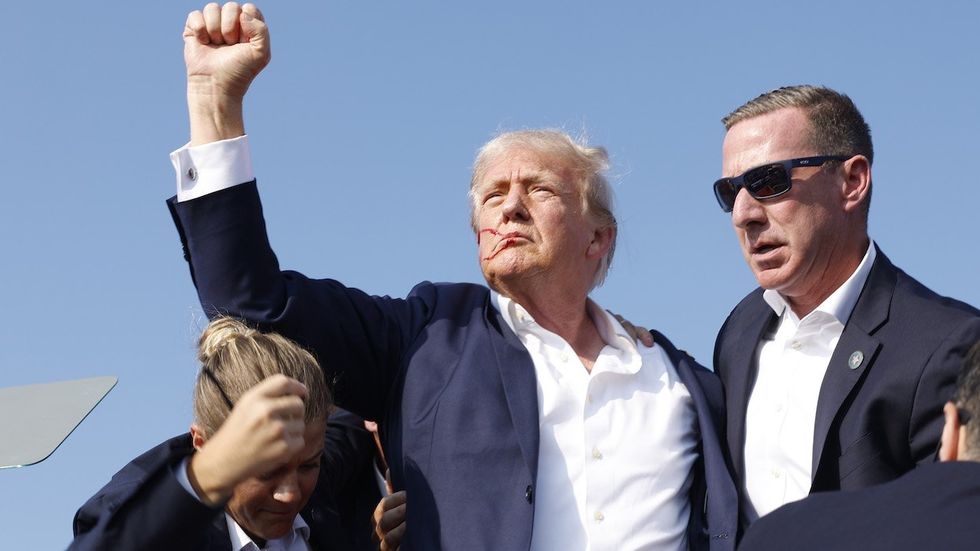 Republican presidential candidate former President Donald Trump is rushed offstage during a rally on July 13, 2024 in Butler, Pennsylvania. 