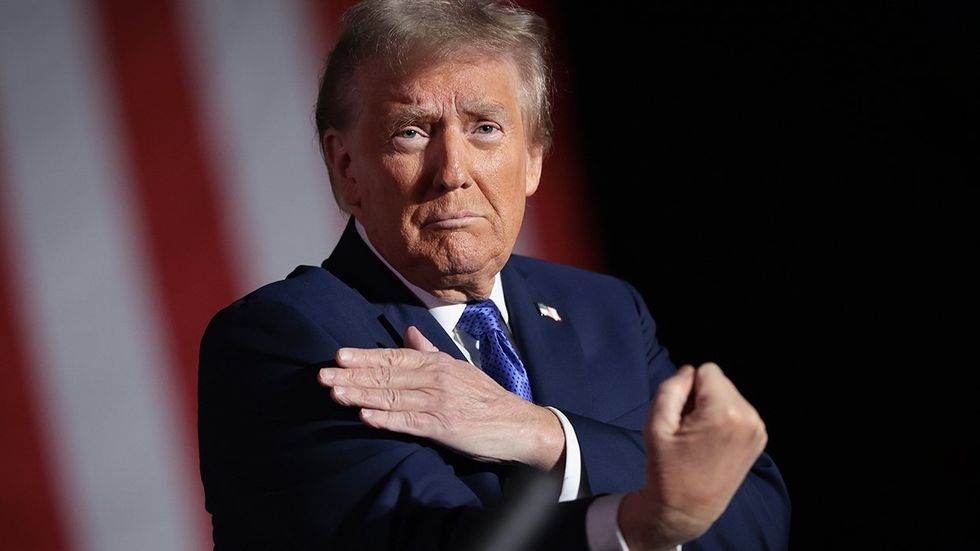 Republican presidential nominee former US President Donald Trump gestures to the crowd as he concludes a campaign rally on October 19 2024 in Latrobe Pennsylvania