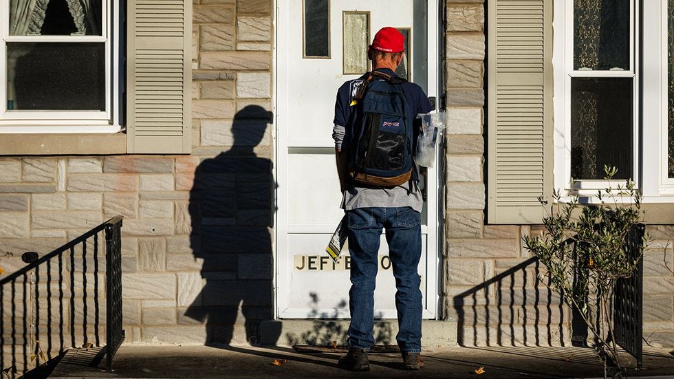 Republican volunteer from Salisbury Township knocks on a door while canvassing a neighborhood in Bethlehem Pennsylvania