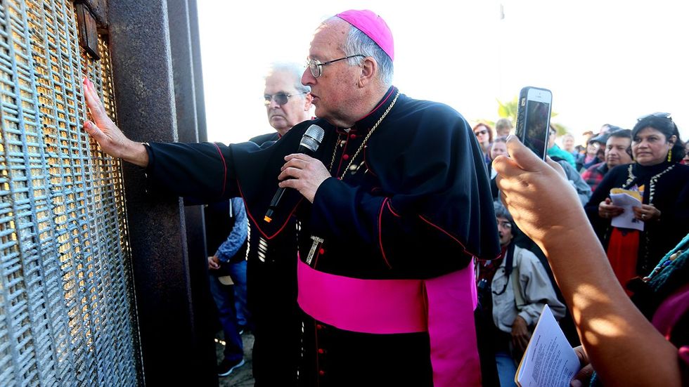 Robert McElroy Archbishop of San Diego worshipers gather on both sides of the USA Mexican border fence for a Christmas celebration