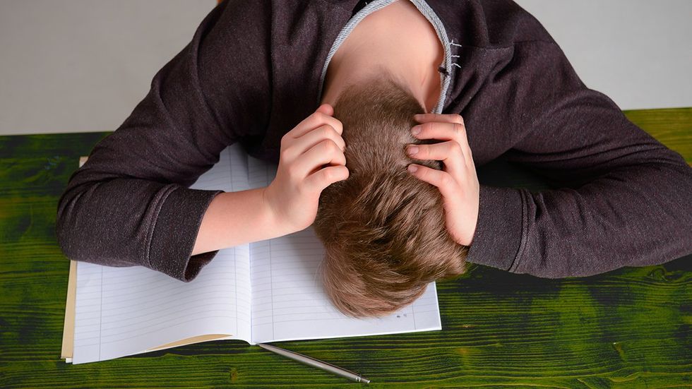 sad student head down notebook open