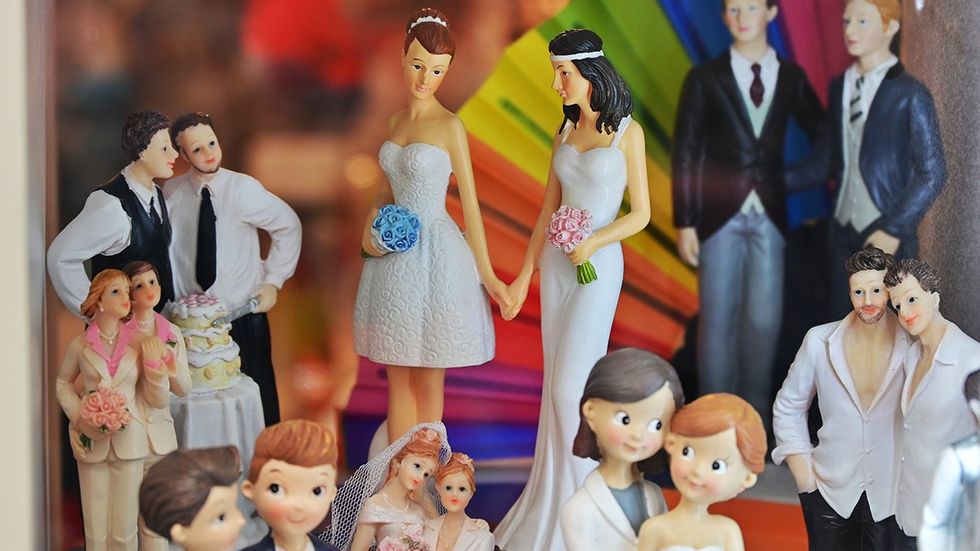 same sex marriage wedding cake toppers rainbow fan background