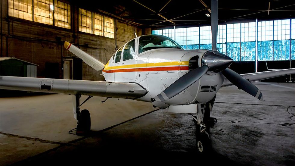 single engine beechcraft bonanza aircraft in hanger