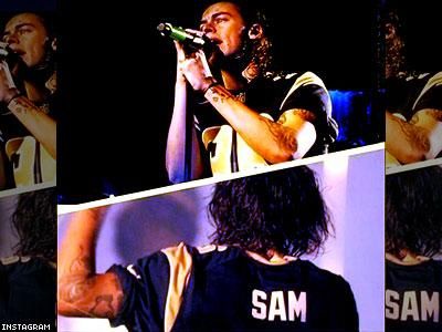 Harry Styles wears a jersey for openly gay NFL player Michael Sam at St.  Louis concert