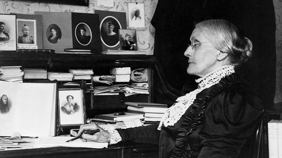 Susan B Anthony leader in the abolitionist and womens suffrage movements seated at a desk