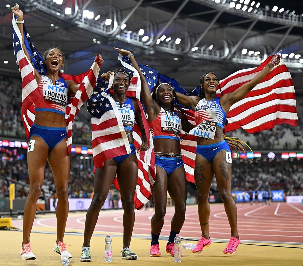 Team USA Gabrielle Thomas Tamari Davis Twanisha Terry and ShaCarri Richardson pose for a photo after winning the final of the women's 4x100 meter relay at the World Athletics Championships in Budapest