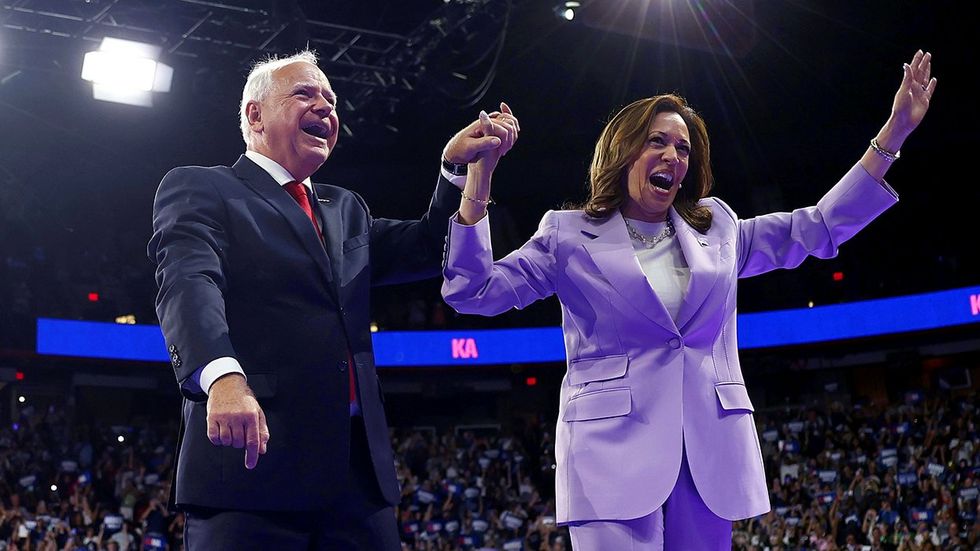 Tim Walz Kamala Harris stage lights purple suit 2024 presidential rally las vegas nevada