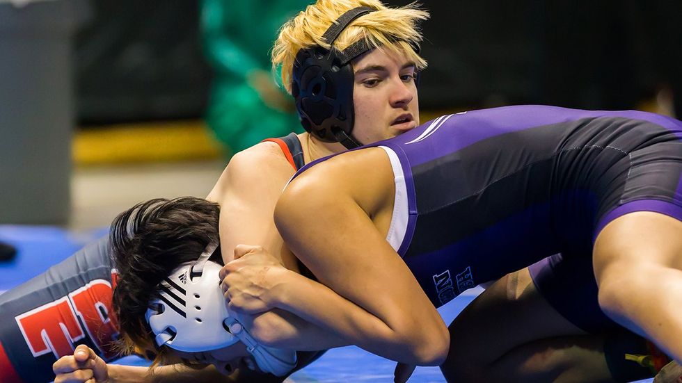 Trinity junior Mack Beggs wrestles Katy Morton Ranch junior Chelsea Sanchez in the final round of the 6A Girls 110 Weight Class match during the Texas Wrestling State Tournament