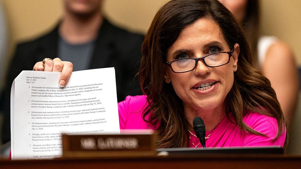 US Rep Nancy Mace holds up papers during a line of questioning