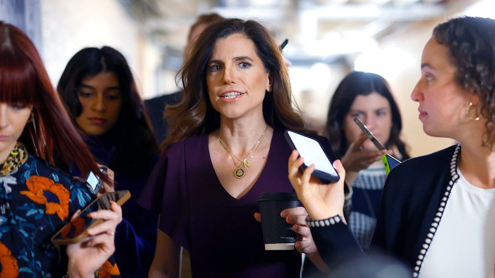 US Rep Nancy Mace surrounded by mostly femme presenting potentially women reporters walking halls congress US Capitol building