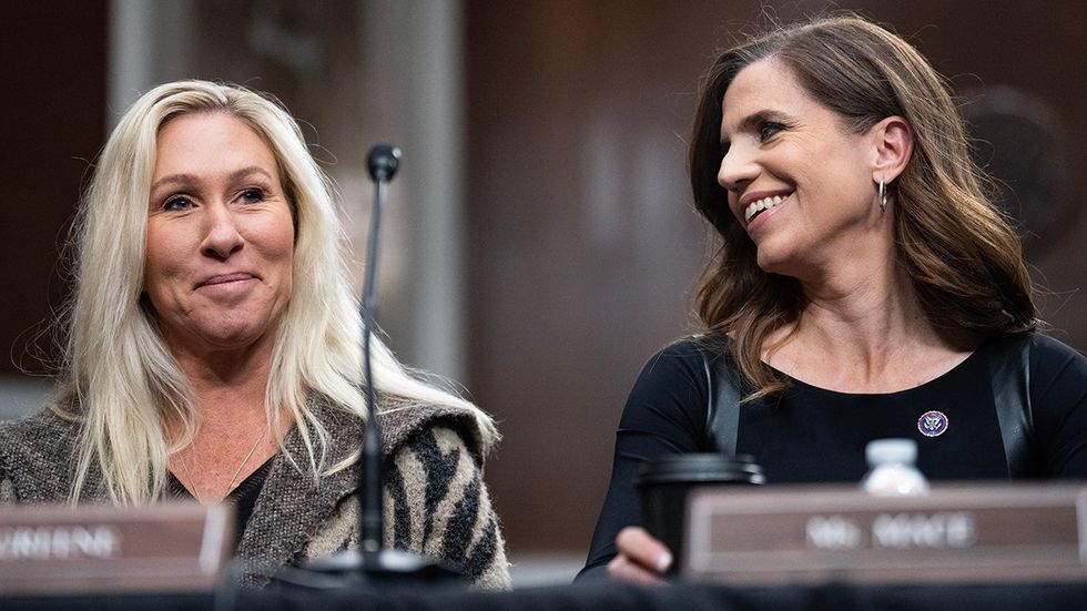 US Reps Marjorie Taylor Greene Nancy Mace side chuckle during committee meeting like mean girls but government