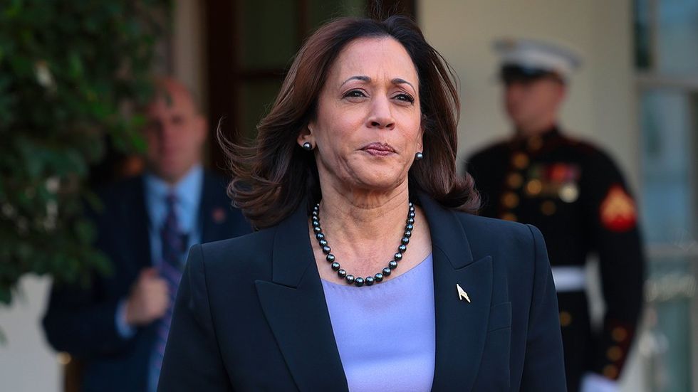 US Vice President Kamala Harris walks toward members of the media outside the White House