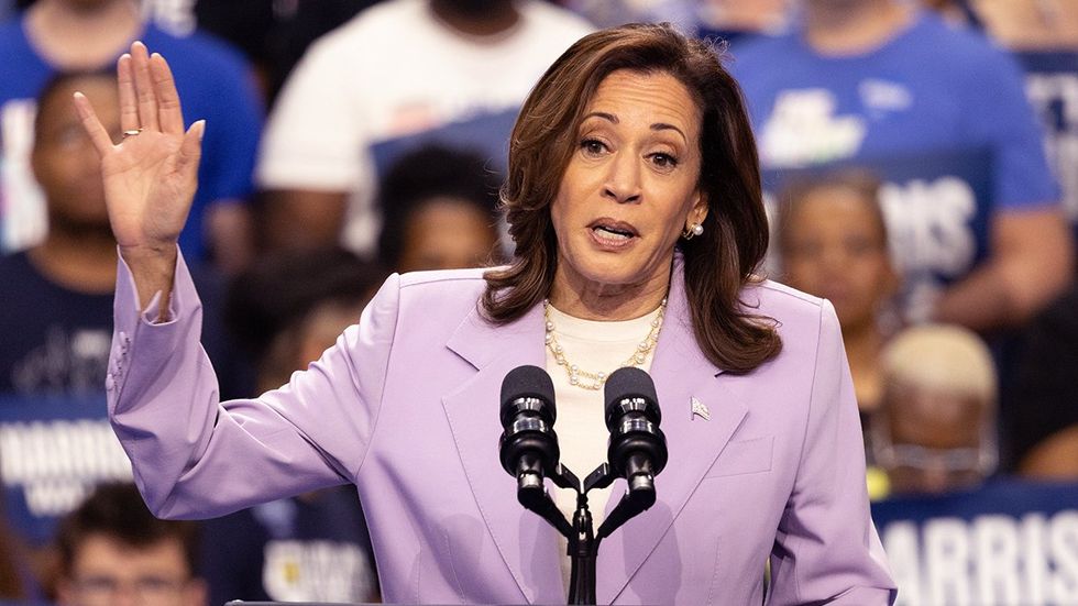 vice president kamala harris speaking at las vegas rally lilac purple blazer