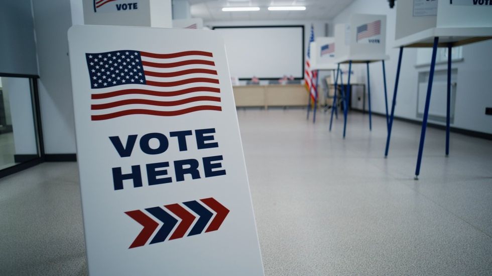 Voting station with "vote here" sign