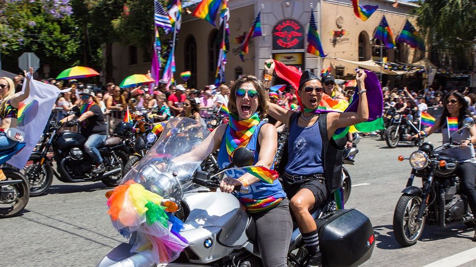 West Hollywood Los Angeles California LGBTQ Pride Parade Dykes on Bikes contingent rainbow flags cheering