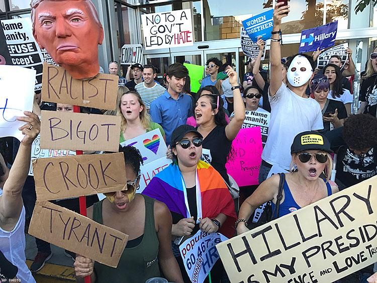 Protesters hold banners during a rally outside the CNN studios in Los Angeles.