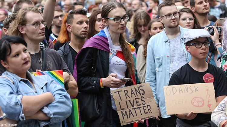 Protesters with rainbow flags and banner during the rally in front of Neptune fountain in Gdansk Poland on 23 July 2019.